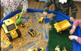 enjoying construction tray at nursery