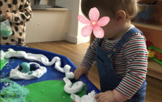 nursery child playing in tray